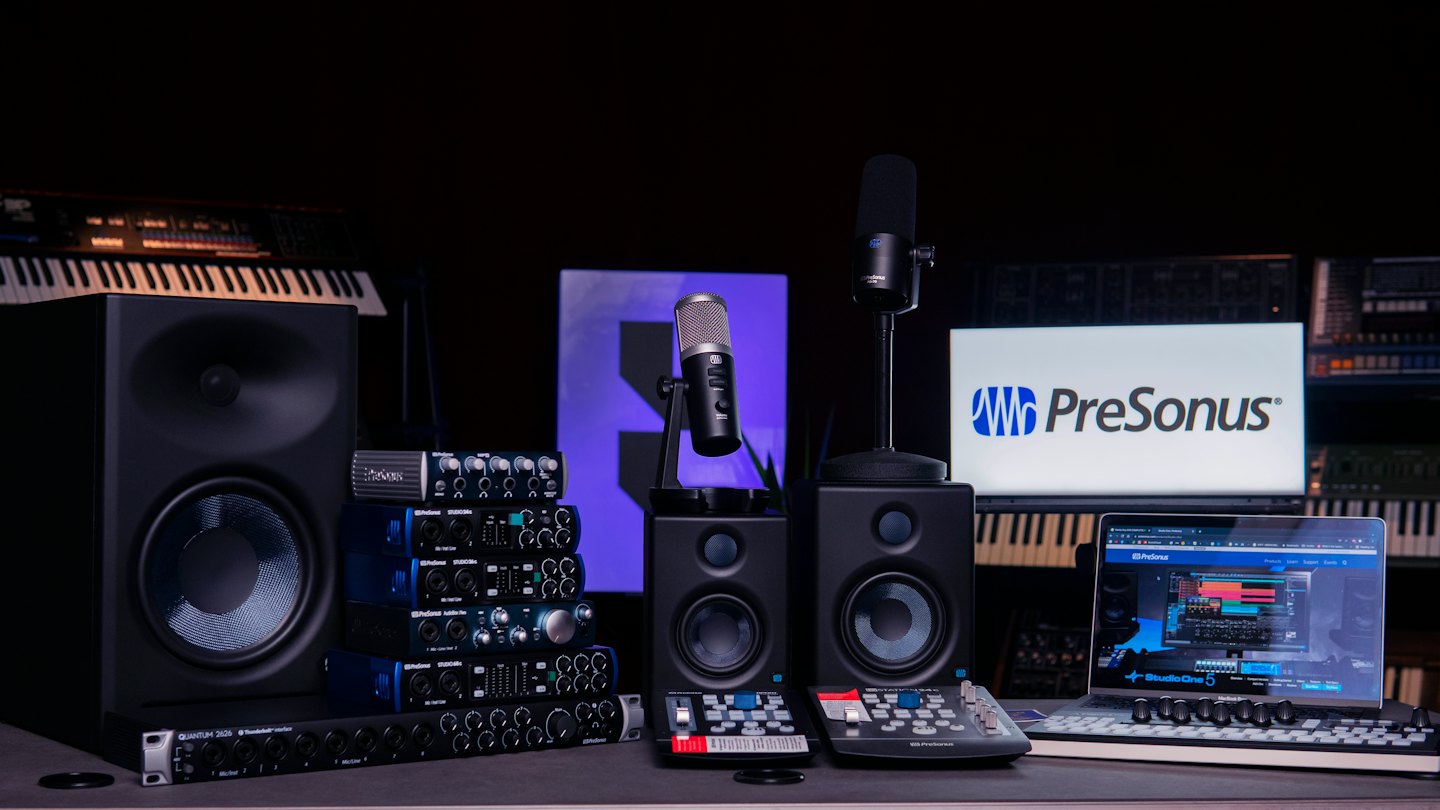 Music production equipment sits arranged on a professional studio desk.