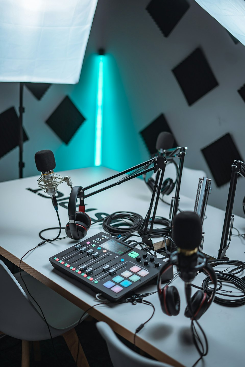 Professional podcast studio with microphones and audio mixer.